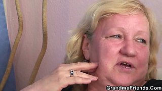 Busty granny in stockings swallows two cocks