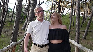 An old guy and a young girl are having sex in nature
