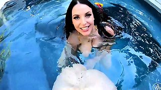 In a kitchen a sexy brunette playing with her big boobs