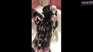 Rubber doll in a gas mask takes a bath