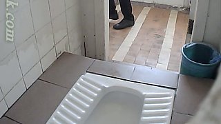 White amateur chick in black pants pissing in the toilet