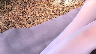 White oil shiny pantyhose in mountain forest