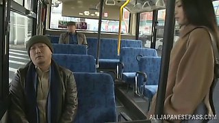 Fancy cougar dressed heavily giving a guy captivating handjob in the bus in reality shoot