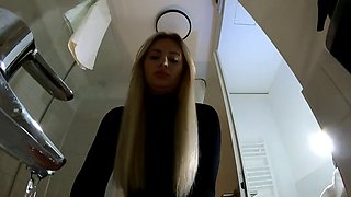 Big Tits Big Ass Hot Blonde Babe in Pantyhose and High Heels with a Miniskirt does a Striptease in the Bathroom