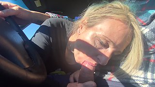 A woman is having a lot of fun in her car with a man.