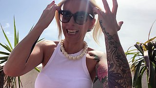 Blonde is flashing her big boobs in the outdoors