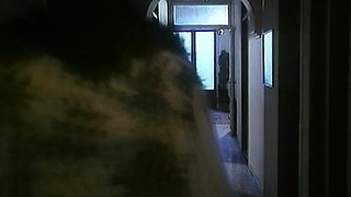 In a kitchen a sexy brunette playing with her big boobs