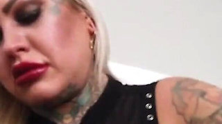Tattooed blonde MILF combing her hair.