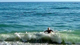 Naked blonde on a Nude beach. Masturbating and pissing.