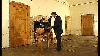 Tied up woman with clitoris piercings, sodomized by a stick