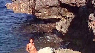 Short haired beauty teasing on the beach