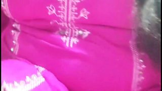 A Bengali woman quenches her thirst with a bottle