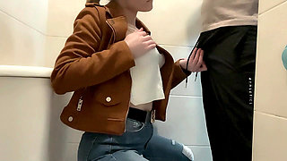 Busty Blonde Sucks Cock in the School Bathroom