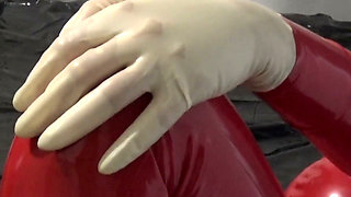 Photoshooting in Red Latex Catsuit with Latex Mask and Transparent Face.