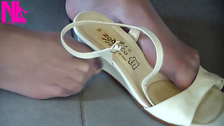 Nyllady Putting on Pantyhose and Footplay with Milk Colored Wedges