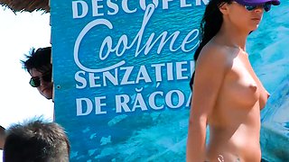 Beautiful fresh faced teen plays at the beach nude