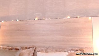 Petite Latina rides dildo in bed on webcam