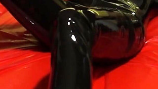 Oil body in latex catsuit