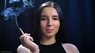 Elegant Brunette Smoking in Black Outfit