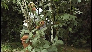 Mature redhead blowing cock in the backyard
