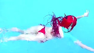 Cosplay redhead teen seductress posing in bikini in the pool